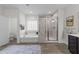 Luxurious bathroom featuring a soaking tub and tiled shower at 420 Creekhurst Pl, Cary, NC 27519