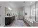 Modern bathroom with double vanity, soaking tub, and plenty of natural light at 420 Creekhurst Pl, Cary, NC 27519