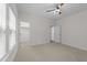 Bright bedroom featuring neutral carpet, ceiling fan and walk-in closet at 420 Creekhurst Pl, Cary, NC 27519