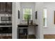 Cozy butler's pantry with a wine cooler, wooden countertop, and natural light from the window at 420 Creekhurst Pl, Cary, NC 27519