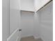 Walk-in closet with neutral colored walls, shelving and ample space for storage and organization at 420 Creekhurst Pl, Cary, NC 27519
