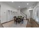Dining room with glass table, staircase, hardwood floors and elegant built-in display cabinets at 420 Creekhurst Pl, Cary, NC 27519