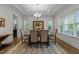 Sophisticated dining room featuring natural light, elegant chandelier, and decorative rug at 420 Creekhurst Pl, Cary, NC 27519