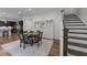 Dining room features a glass table, staircase, hardwood floors and elegant built-in display cabinets at 420 Creekhurst Pl, Cary, NC 27519