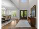 Bright dining room featuring hardwood floors, elegant lighting, and a view to the front yard at 420 Creekhurst Pl, Cary, NC 27519
