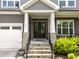 Inviting front entrance with stone accents, double doors and covered porch at 420 Creekhurst Pl, Cary, NC 27519