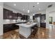 Spacious kitchen with an island, dark cabinetry, stainless steel appliances, and hardwood floors at 420 Creekhurst Pl, Cary, NC 27519