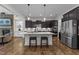 Modern kitchen featuring an island with seating, stainless steel appliances, and custom cabinets at 420 Creekhurst Pl, Cary, NC 27519