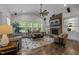 Bright living room features a stone fireplace, hardwood floors, and large windows with backyard views at 420 Creekhurst Pl, Cary, NC 27519