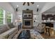 Living room showcasing a stone fireplace, built-in shelving, hardwood floors and backyard view at 420 Creekhurst Pl, Cary, NC 27519