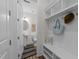 Charming mudroom featuring built-in shelving, hooks, and a convenient powder room at 420 Creekhurst Pl, Cary, NC 27519