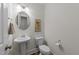 Elegant powder room with pedestal sink and modern fixtures at 420 Creekhurst Pl, Cary, NC 27519