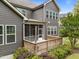 Exterior view of screened-in porch with wooden deck, beautiful landscaping at 420 Creekhurst Pl, Cary, NC 27519