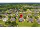 An aerial view of a serene neighborhood with well-maintained lawns and lush greenery, showing a home with a screened porch at 4266 Aviemore Run, Burlington, NC 27215