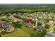 An aerial view of a residential area highlighting the home's location, surrounded by trees and well-manicured lawns at 4266 Aviemore Run, Burlington, NC 27215