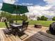 Backyard offers an outdoor dining set, large green umbrella, and fire pit area perfect for entertaining at 4266 Aviemore Run, Burlington, NC 27215
