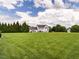 The house is surrounded by a well-manicured lawn, offering a serene and private outdoor space at 4266 Aviemore Run, Burlington, NC 27215