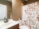 A full bathroom with a floral shower curtain and classic fixtures at 4266 Aviemore Run, Burlington, NC 27215