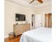 Bedroom features tray ceilings, a dresser with a television and hardwood floors at 4266 Aviemore Run, Burlington, NC 27215
