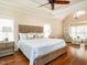 Bright bedroom with tray ceilings, a wooden bed frame and hardwood floors at 4266 Aviemore Run, Burlington, NC 27215