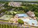 An aerial view of community amenities: tennis courts, swimming pool, and clubhouse, enhancing a vibrant and active lifestyle at 4266 Aviemore Run, Burlington, NC 27215