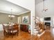 Open-concept living room with hardwood floors, fireplace, and staircase leading to upper level at 4266 Aviemore Run, Burlington, NC 27215