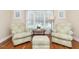 Cozy living room features patterned chairs, ottoman, hardwood floors and natural light at 4266 Aviemore Run, Burlington, NC 27215