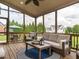 Spacious screened porch with comfortable seating provides the perfect spot for relaxation and outdoor entertainment at 4266 Aviemore Run, Burlington, NC 27215