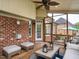 Relaxing screened porch features brick accents, ceiling fan, and comfortable seating area perfect for outdoor enjoyment at 4266 Aviemore Run, Burlington, NC 27215