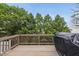 Large back deck with wood floors, backyard views and a grill for outdoor entertainment at 4621 Youngsbury Ct, Raleigh, NC 27604