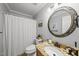 Well-lit bathroom with granite countertop, decorative mirror, and shower curtain at 4621 Youngsbury Ct, Raleigh, NC 27604