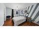 Stylish bedroom with hardwood floors, ample lighting and a unique accent wall at 4621 Youngsbury Ct, Raleigh, NC 27604