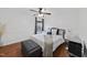 Bright bedroom featuring a ceiling fan, wood floors, accent pillows and side tables at 4621 Youngsbury Ct, Raleigh, NC 27604