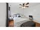 Bright bedroom featuring a ceiling fan, wood floors, accent pillows and side tables at 4621 Youngsbury Ct, Raleigh, NC 27604
