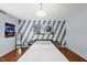 Inviting bedroom features a modern design, stylish decor, and hardwood flooring at 4621 Youngsbury Ct, Raleigh, NC 27604