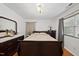 Inviting bedroom with dark wood furniture, natural light and hardwood floors at 4621 Youngsbury Ct, Raleigh, NC 27604