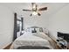 Bright bedroom featuring a ceiling fan, wood floors, accent pillows and side tables at 4621 Youngsbury Ct, Raleigh, NC 27604