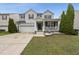 Charming two-story home featuring a covered porch, two-car garage and manicured lawn at 4621 Youngsbury Ct, Raleigh, NC 27604