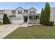 Charming two-story home featuring a covered porch, two-car garage and manicured lawn at 4621 Youngsbury Ct, Raleigh, NC 27604