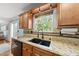 Well lit kitchen with stainless steel appliances, tile backsplash, and view from window at 4621 Youngsbury Ct, Raleigh, NC 27604
