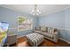 Comfortable living room featuring blue walls, a patterned ottoman, and a neutral sofa at 4621 Youngsbury Ct, Raleigh, NC 27604