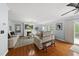 Bright living room featuring hardwood floors, fireplace, and sliding glass door to outside at 4621 Youngsbury Ct, Raleigh, NC 27604