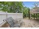 Cozy brick patio featuring comfortable seating and a well-maintained white fence for added privacy at 4621 Youngsbury Ct, Raleigh, NC 27604