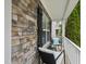 A cozy covered porch with stone accents, seating, and a white railing at 4621 Youngsbury Ct, Raleigh, NC 27604