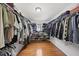 Walk-in closet with hardwood floors and custom shelving at 4621 Youngsbury Ct, Raleigh, NC 27604