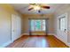 Cozy bedroom with hardwood floors, ceiling fan, and large windows at 504 Hillcrest Ave, Burlington, NC 27215
