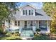 Charming two-story home featuring a welcoming front porch and landscaped front yard at 504 Hillcrest Ave, Burlington, NC 27215