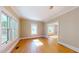 Sun-filled living room featuring hardwood floors, large windows, and adjacent dining area at 504 Hillcrest Ave, Burlington, NC 27215