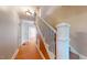 Traditional staircase featuring wood railings and a light-filled hallway at 504 Hillcrest Ave, Burlington, NC 27215