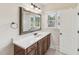 Neutral bathroom featuring a shower-tub combo and a dark wood vanity with a white countertop and natural light at 528 Bankhead Dr, Cary, NC 27519